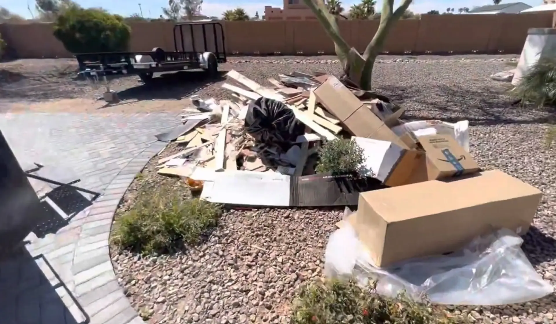 Household junk and boxes cleared from a driveway