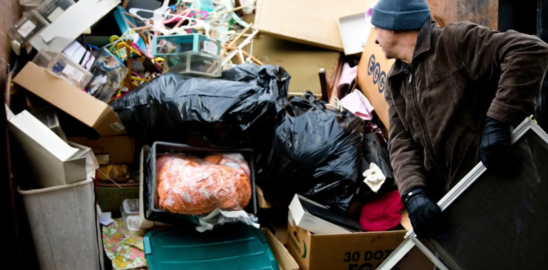 Crew loading mixed household junk and clutter for haul-away