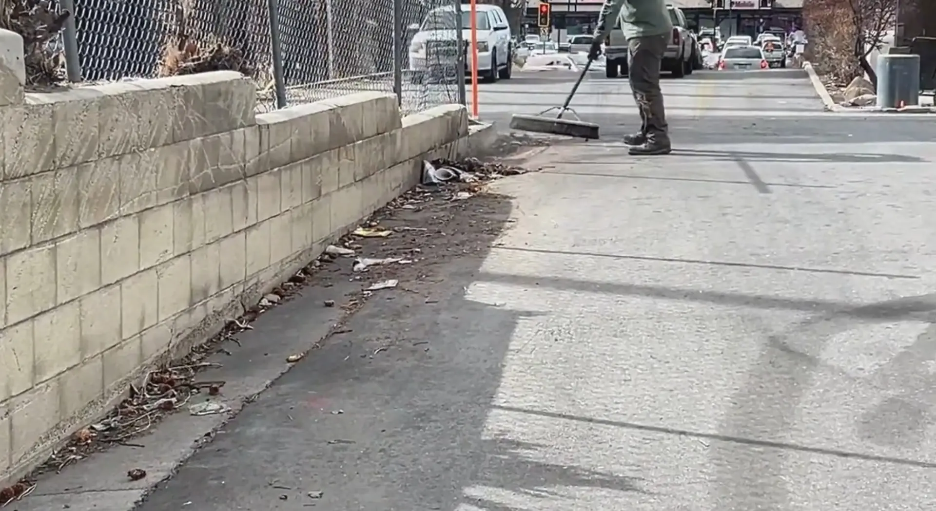Crew sweeping curb debris during a residential cleanup job